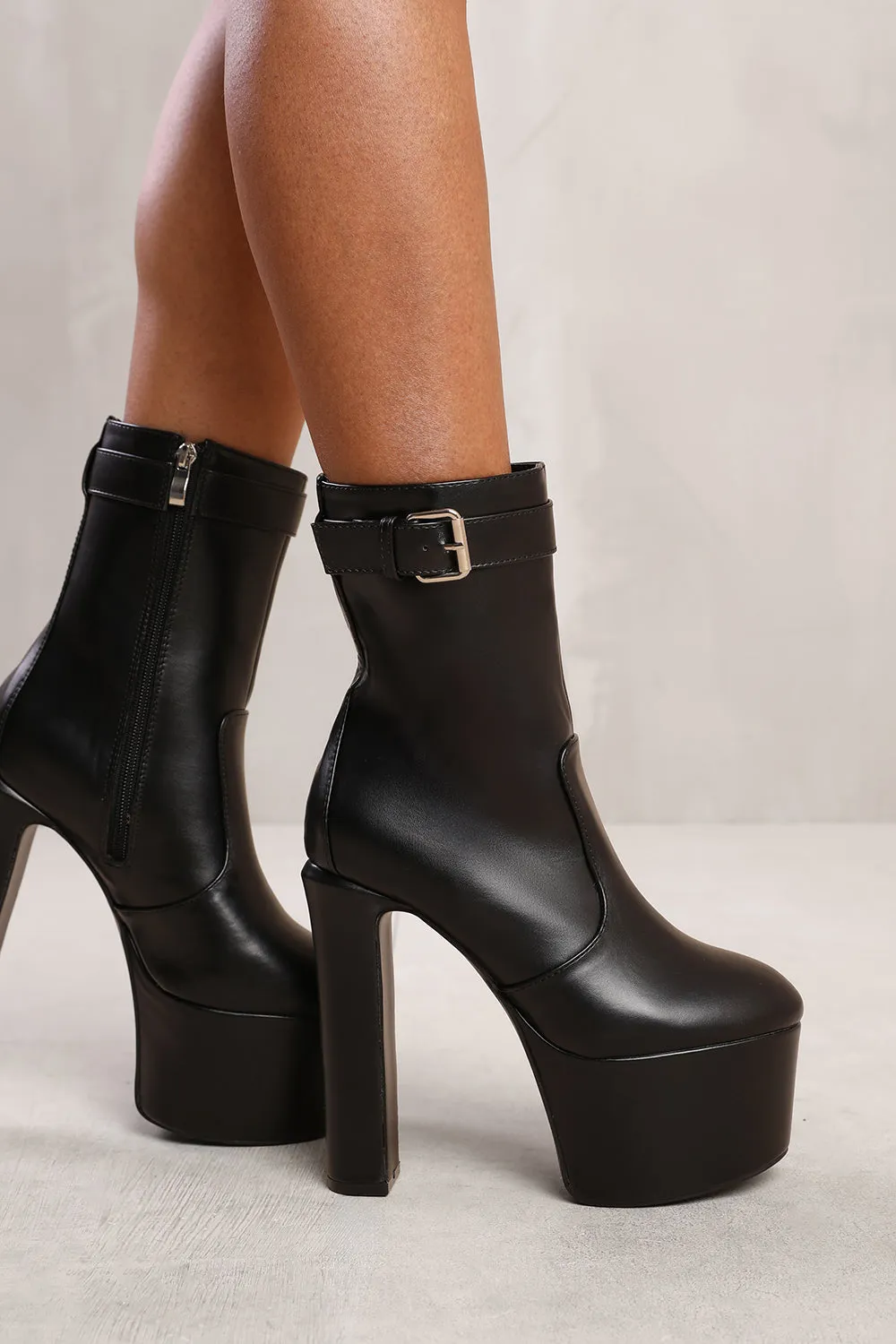 JEANNE PLATFORM BLOCK HEEL ANKLE BOOTS WITH BUCKLE FASTENING IN BLACK FAUX LEATHER